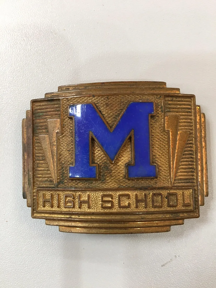 Brass belt buckle with a blue enamel M above High School in Art Deco lettering